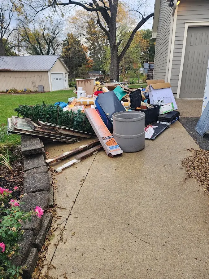 Dumpster being loaded with debris for 12 Yard Dumpster Rental in Citrus Park